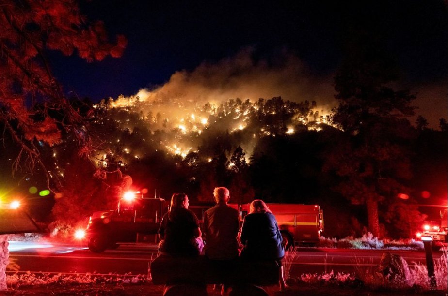 people watching a wildfire