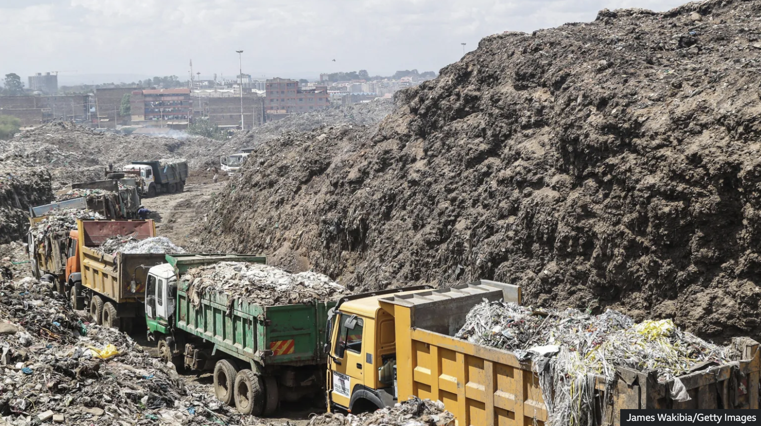 trucks full of plastic in a landfill