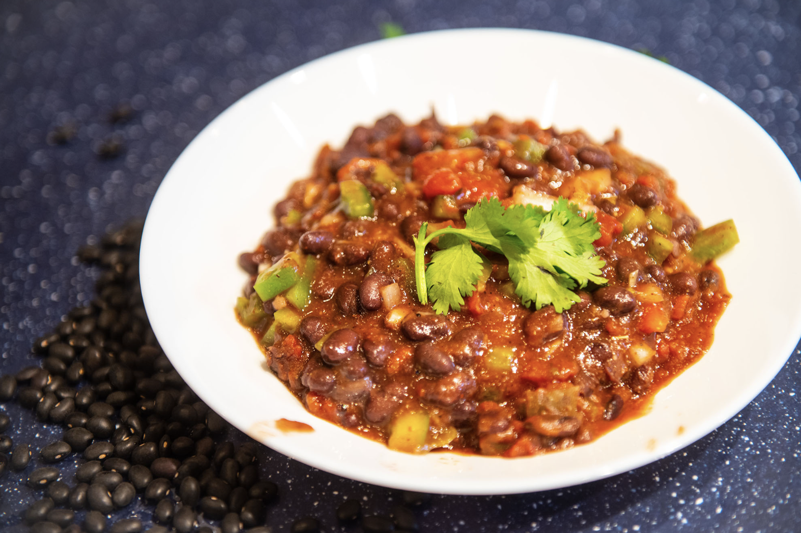 a bowl of plant-based chili garnished with cilantro