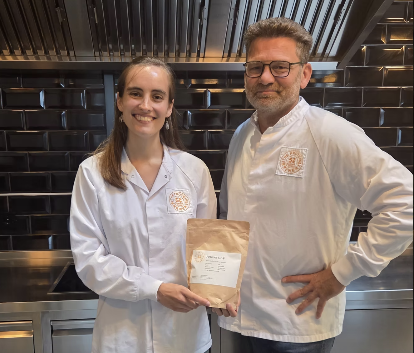 Two Protein Brewery staff holding a bag of their product, Fermotein