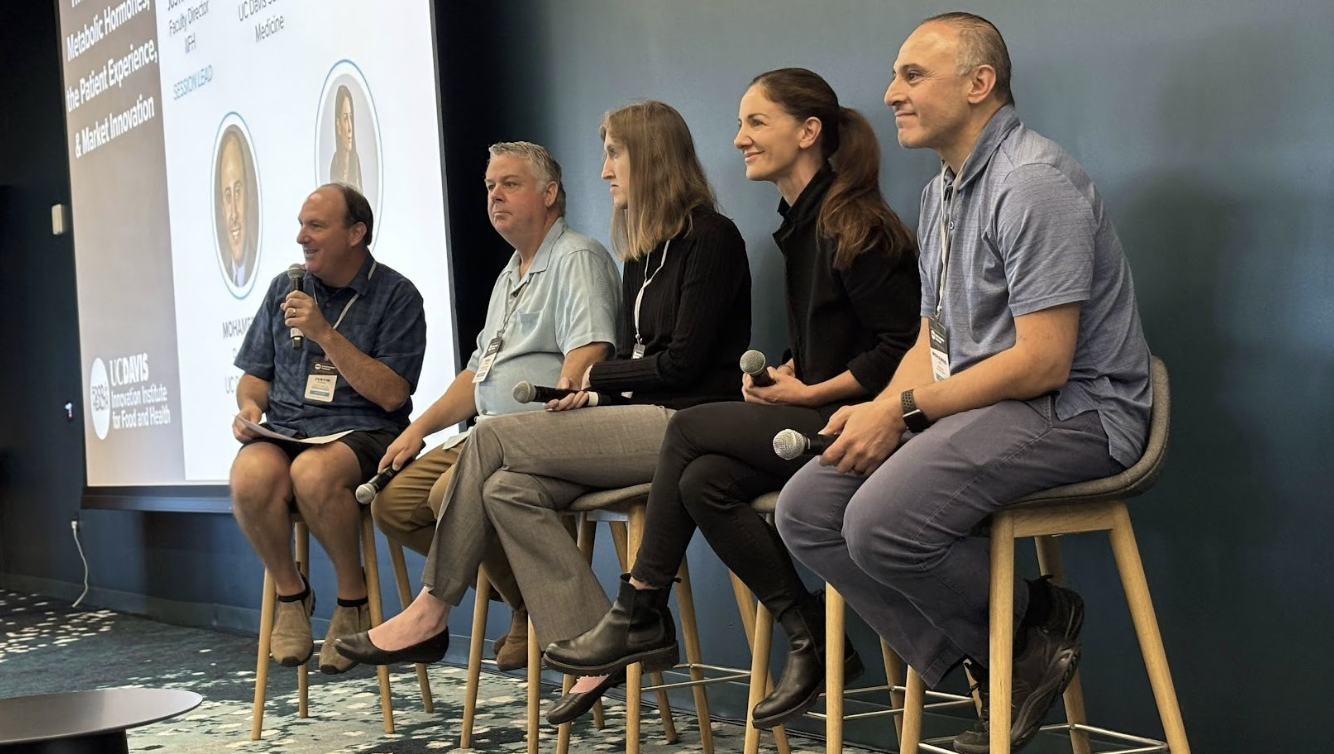 People presenting at a conference, including Dr. Sean Adams